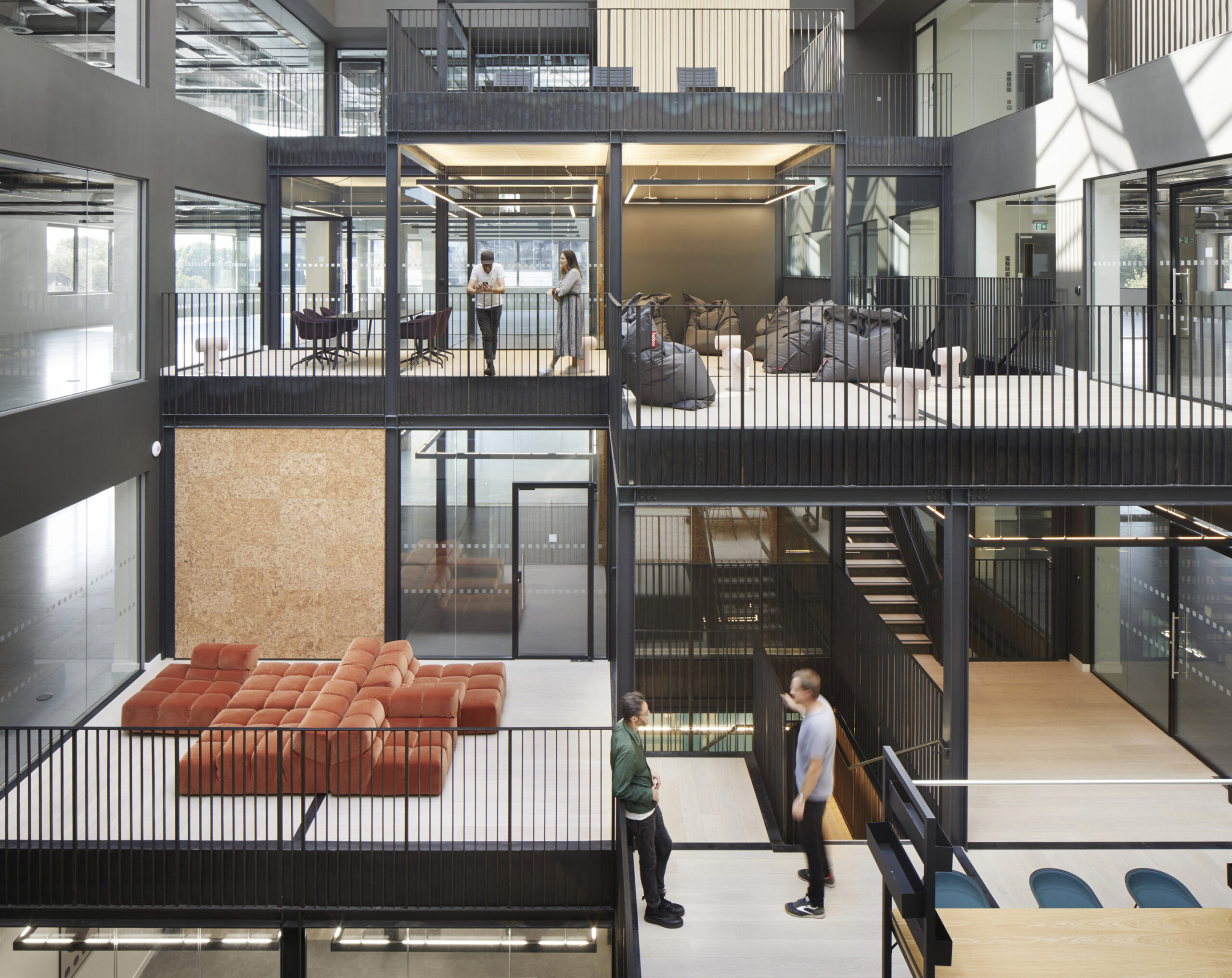 People chatting on different floors in the Forge building