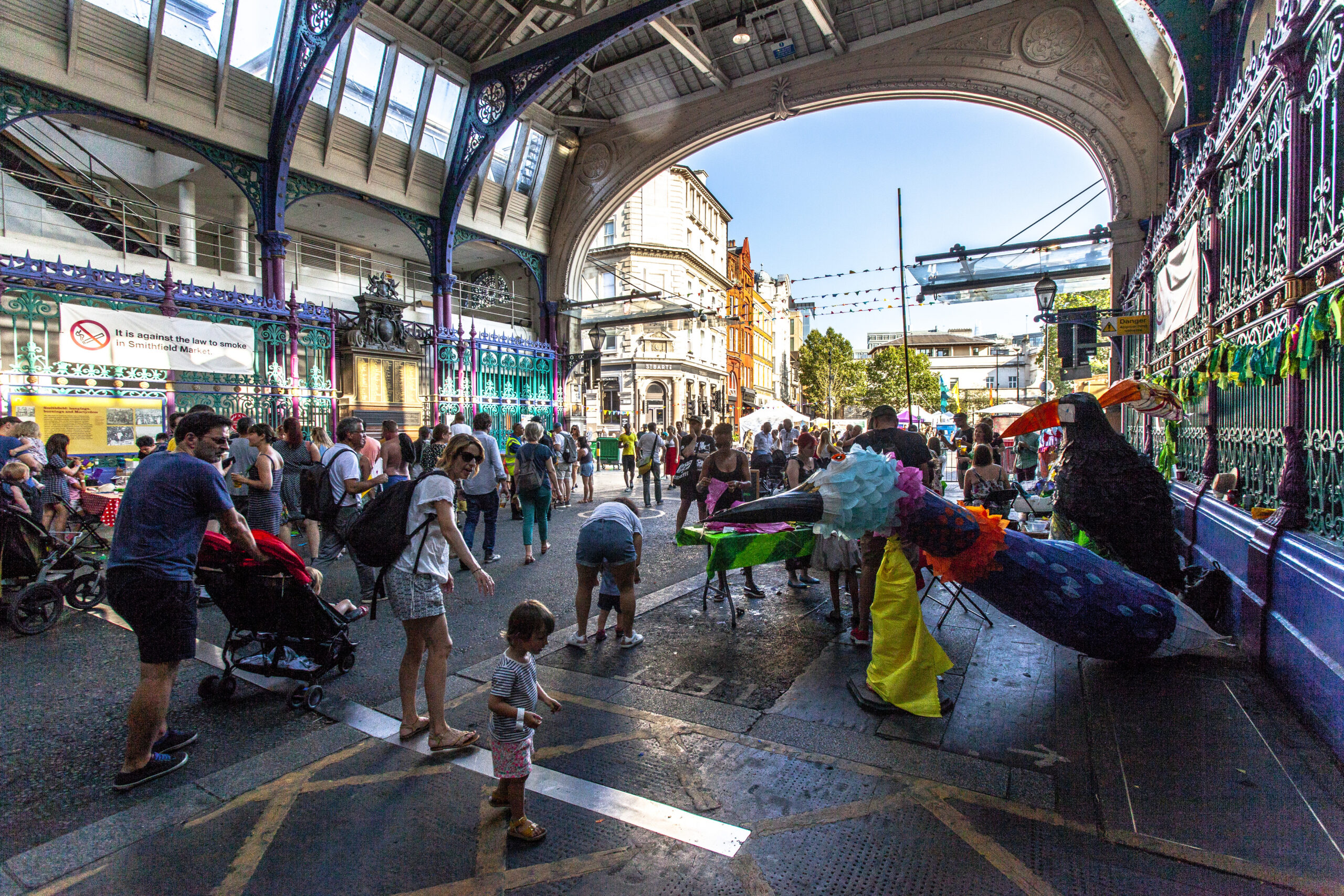 An image of the market hall building at Smithfield with families enjoying an exhibition of large model bird