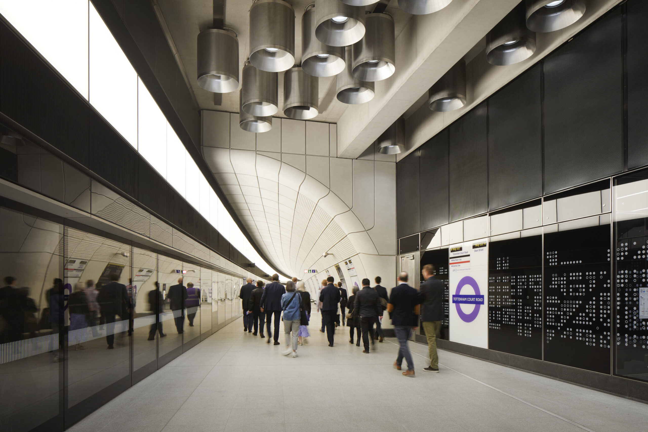 People walking along the Interior platform