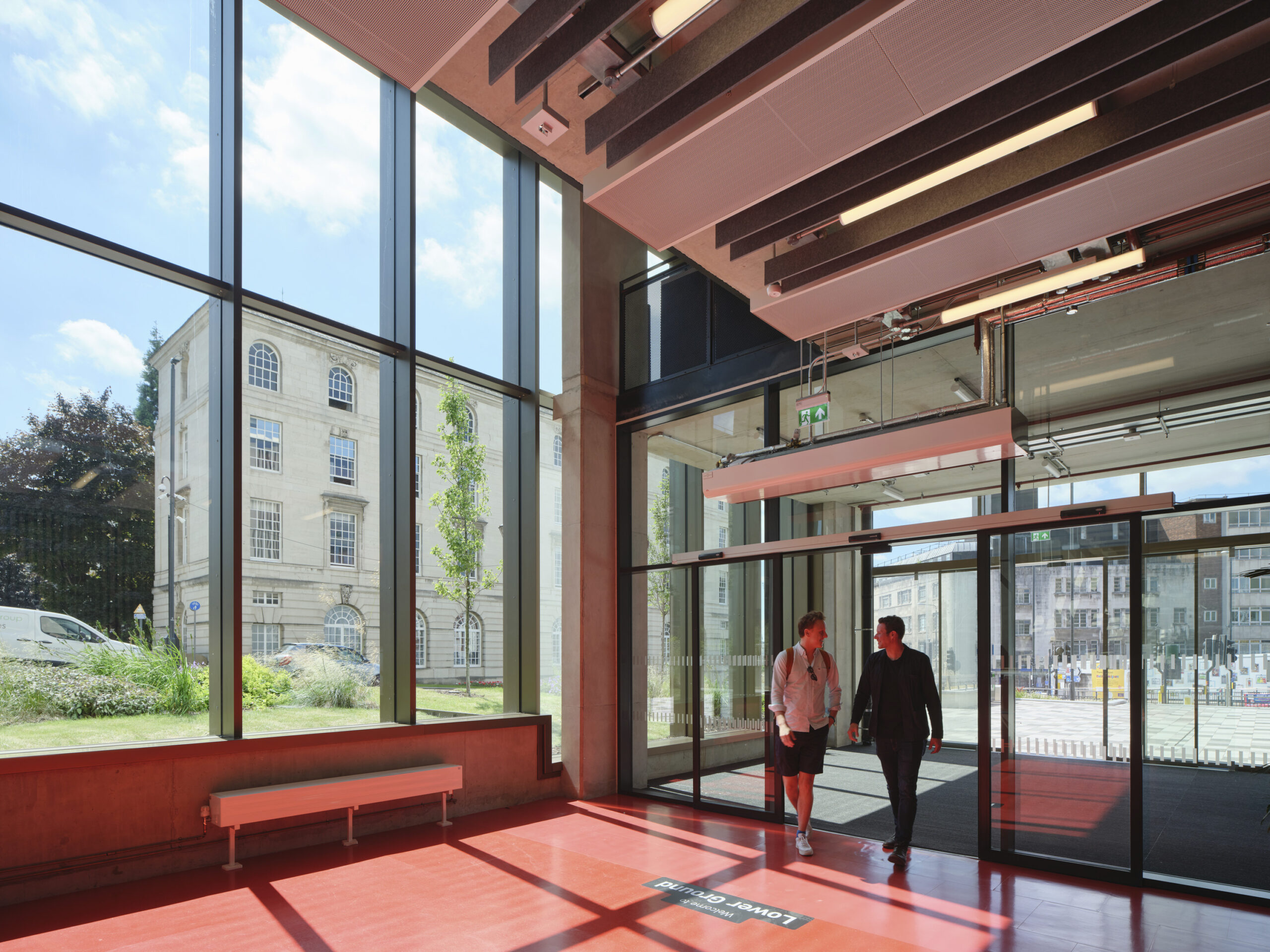 Two men walking into the lower ground entrance at the Leeds Beckett University School of Art