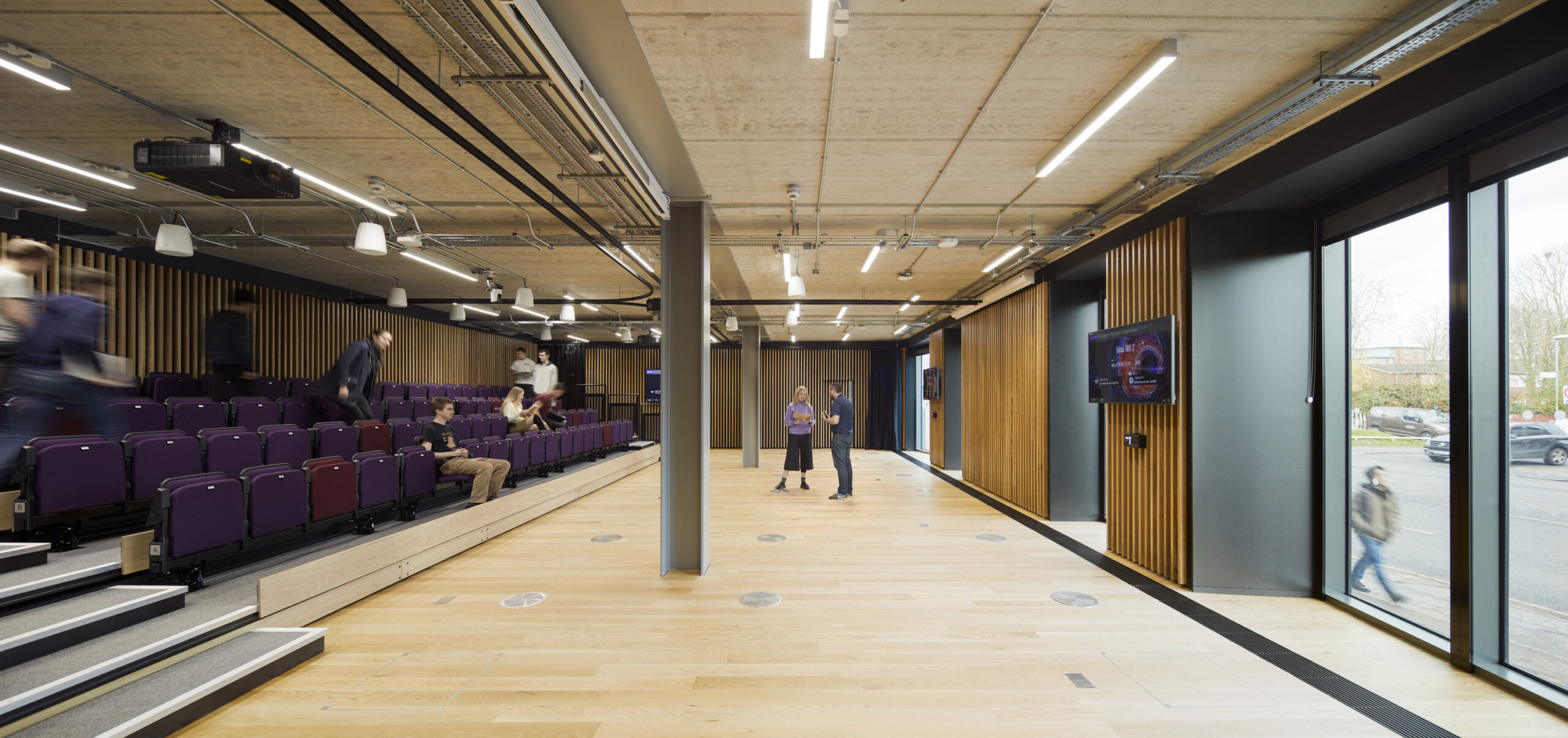 People sat in chairs in the Ideas Mill teaching space at University of Manchester Schuster Annexe-Ideas Mill