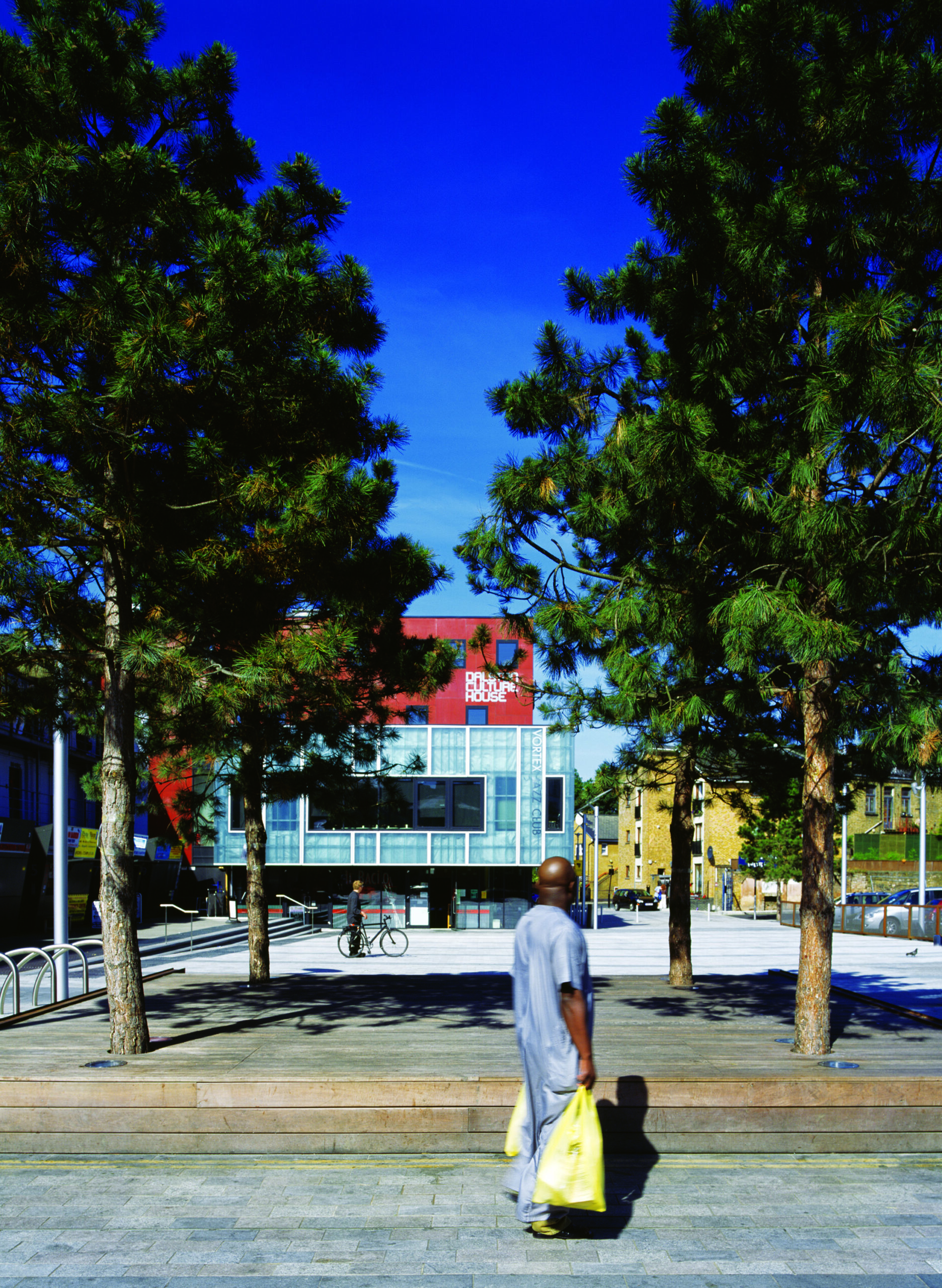 A man holding his shopping bags while looking at Gillett Square