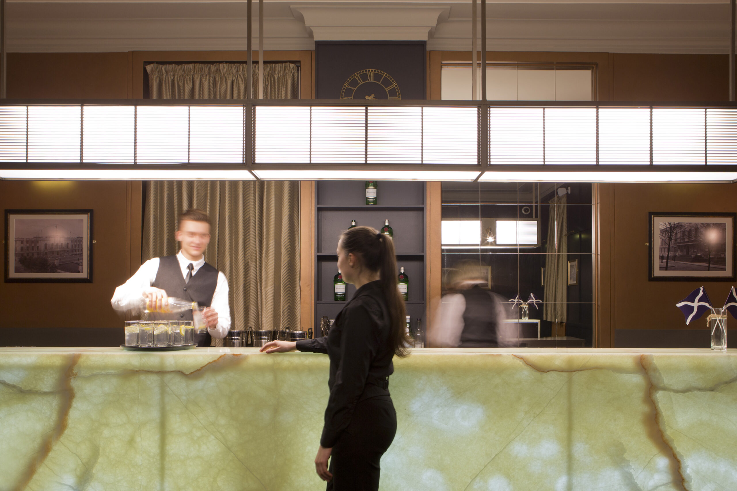 A woman getting a drink for the bar at Hackney Town Hall.