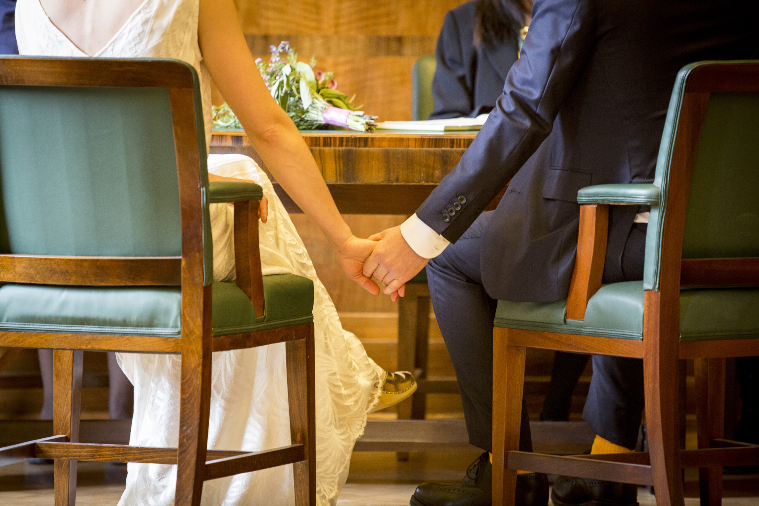 Two people holding hands in the wedding suite at Hackney Town Hall