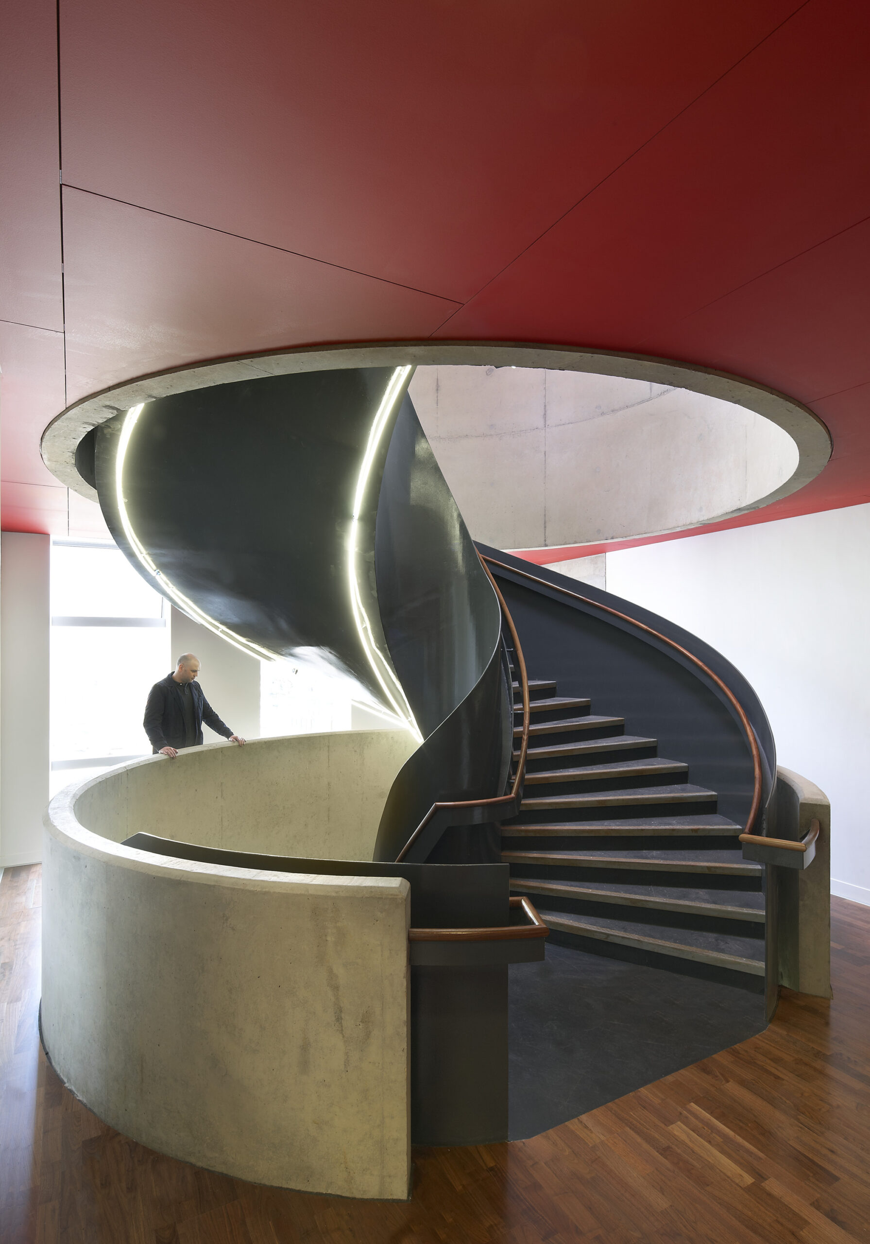 Interior shot of man looking down a spiral staircase